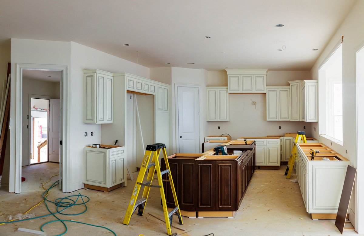 A kitchen remodel in progress with a yellow ladder in El Paso.